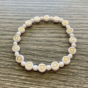 White and gold bracelet accented with white jade. One size